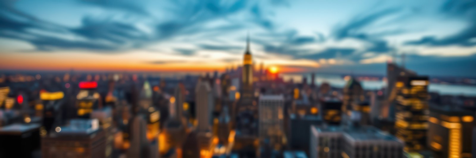 Stunning sunset over an urban skyline featuring iconic landmarks and distant water views
